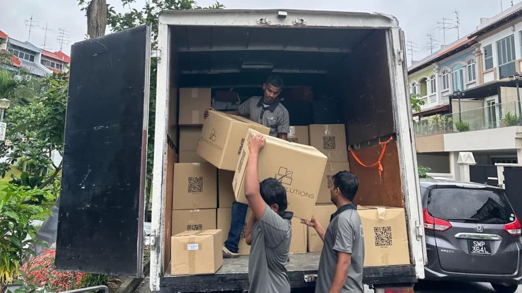 Moving Solutions crew loading furniture into a moving truck