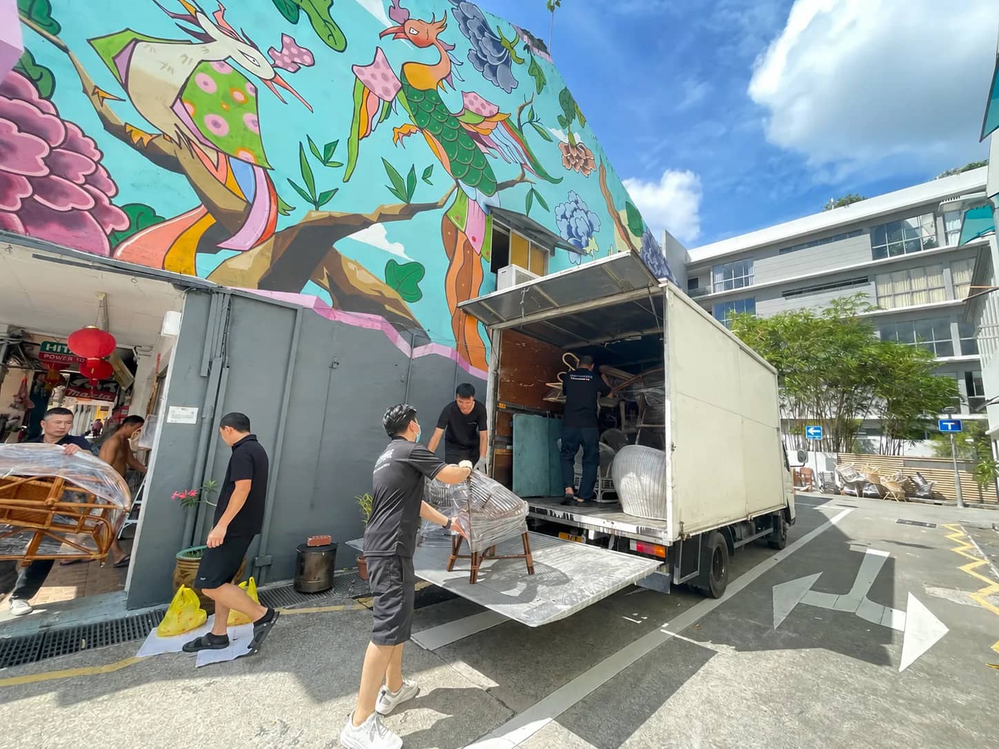 Moving Solutions crew loading wrapped chairs onto a truck during a retail storage collection